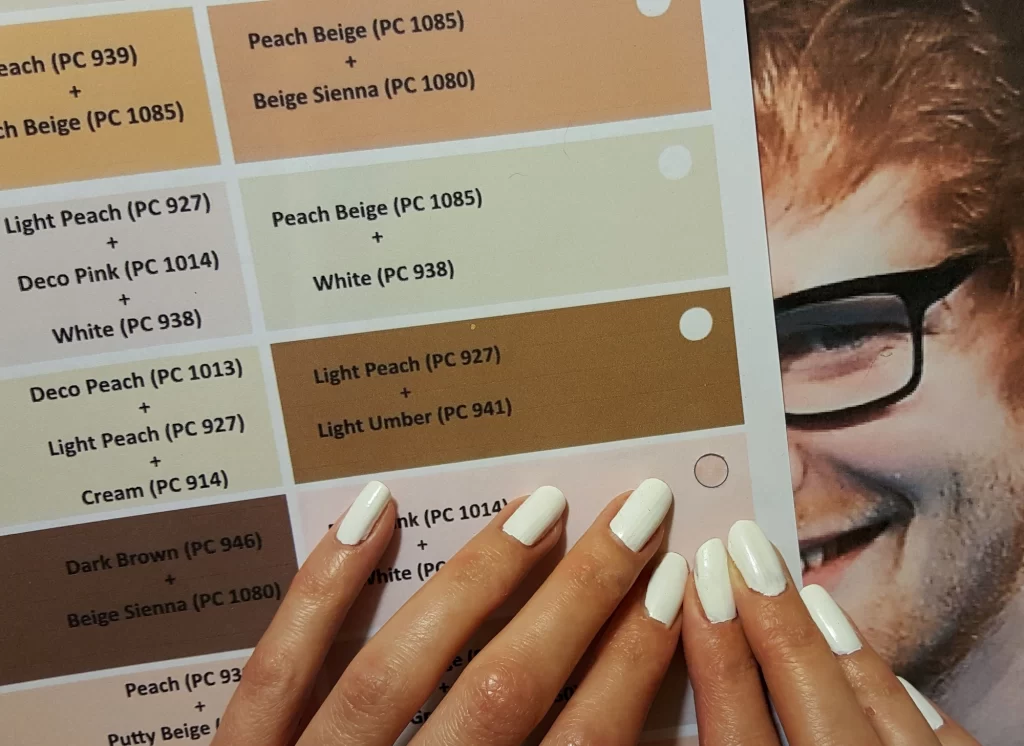 artists matches colored pencil swatches to a reference photo