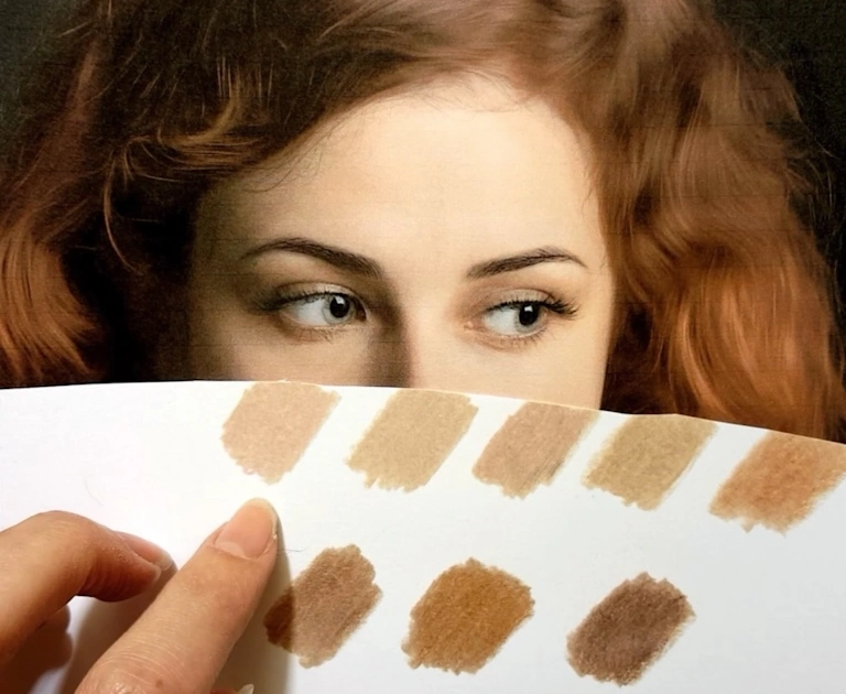 color swatches artist compares to reference photo to choose colors for drawing