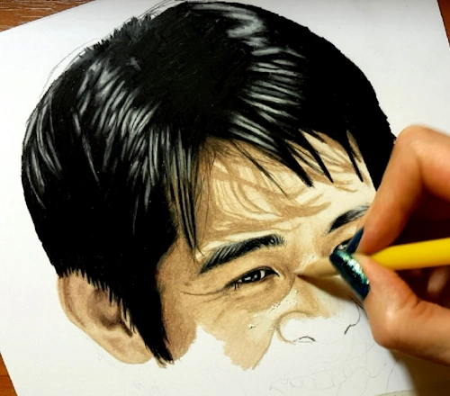 drawing in progress showing how to shade and blend the skin tones in colored pencil